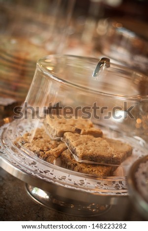A plate of warm cookies with a glass covering