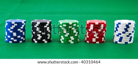 Gambling stacked chips on green felt