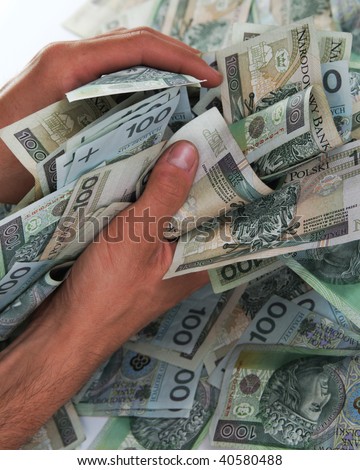 Greedy hand grabs money lot of polish banknotes