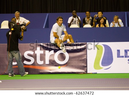 SHAH ALAM, MALAYSIA - OCTOBER 8: Australian Pat Cash teasing the fans at Showdown of Champions Tennis on October 8, 2010 in Shah Alam, Malaysia