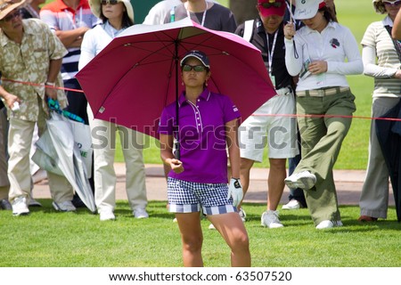 KUALA LUMPUR, MALAYSIA - OCTOBER 22: Japan Ai Miyazato shades under umbrella waiting for her shot on Day 1 Sime Darby LPGA Golf October 22, 2010 in Kuala Lumpur, Malaysia. Miyazato leads day 1 scores
