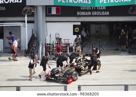SEPANG, MALAYSIA - MARCH 23: French Romain Grosjean of Team Lotus pushed back to his pit garage during Friday practice at Petronas Formula 1 Grand Prix March 23, 2012 in Sepang, Malaysia