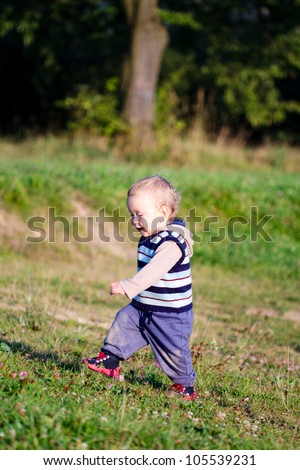 First steps of baby on nature background