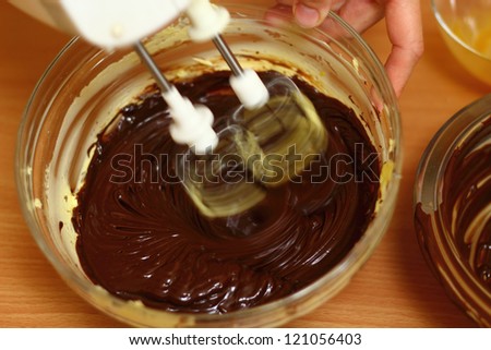 Making Chocolate Sponge Cake. Series. Beating chocolate, eggs and butter with a whisk.