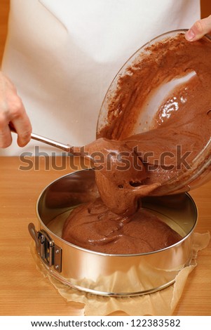 Pouring cake mix into baking tin (springform). Making Chocolate Layer Cake. Series.