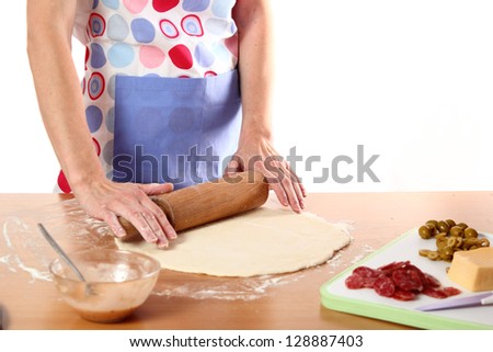 Making Pizza with Salami, Olives and Cheese. Series. Preparing dough sheet for pizza. Rolling out.