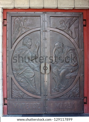 Metal Door with Pictures of St. Mark and Matthew in Catholic Church. Rytro, Poland.