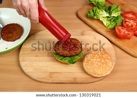 Making Hamburger. Series. 8/15. Spread Ketchup on Patty.
