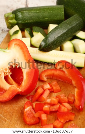 Cooking Red Bell Pepper and Zucchini. Cutting.