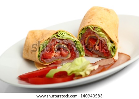Wrap tortilla sandwich with ham, tomato, lettuce. Isolated with clipping path.