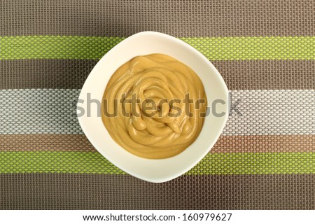 Mustard in bowl. Directly above.