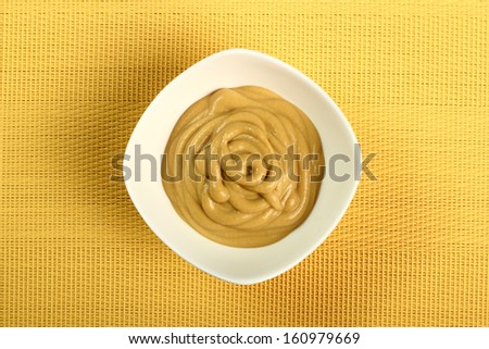 Mustard in bowl. Directly above.