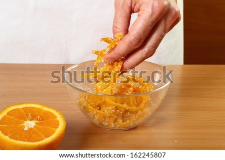 Coating orange peels with sugar. Candied Orange Zest Cooking. Series.
