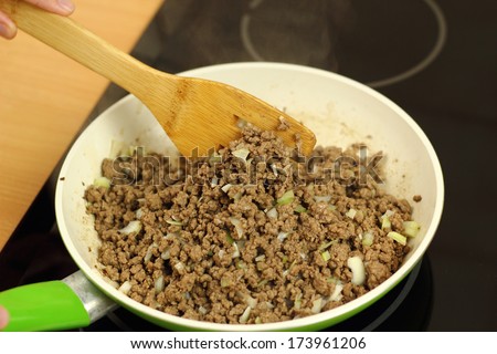 Pan frying ground beef with onion and garlic. Making enchilada tortilla with beef. Series.