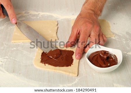 Spreading chocolate. Making Chocolate Croissants with Puff Pastry