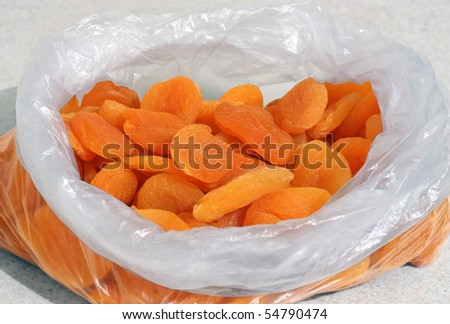 dried apricots in plastic bag on a table