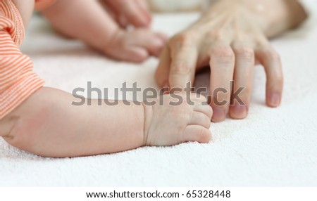 Child clings to mother\'s finger