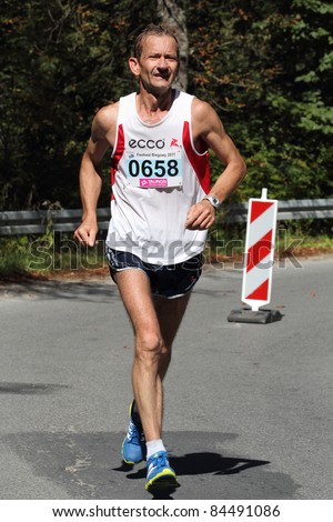 KRYNICA-ZDROJ, POLAND - SEPT 11: The runner Pulik Jerzy is running a marathon (control point 39km) at Economic Forum Polish Running Festival September 11, 2011 in Krynica-Zdroj, Poland