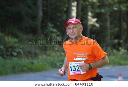 KRYNICA-ZDROJ, POLAND - SEPT 11: The runner Brzozowski Leszek is running a marathon (control point 39km) at Economic Forum Polish Running Festival September 11, 2011 in Krynica-Zdroj, Poland