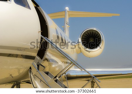 Private jet at a small airport with stairway down waiting to take on passengers