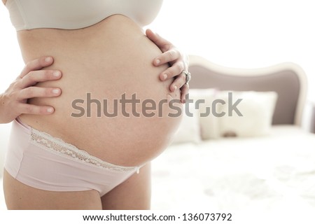 Coming Soon (Beautiful belly of a pregnant woman)