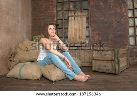 Girl sitting on the sacks