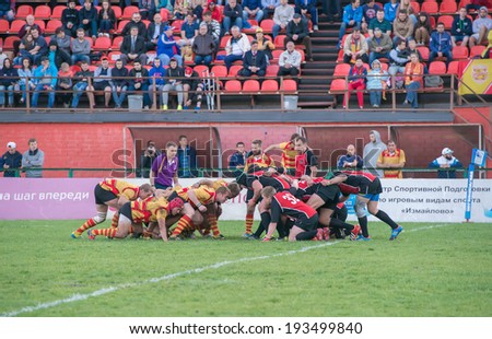MOSCOW - MAY 13: Some players in a scrum in the Russian Rugby Championship 2014 match between Slava CSP (yellow) and Metallurg (black), on May 13, 2014, in Moscow stadium Slava Russia.