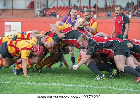 MOSCOW - MAY 13: Some players in a scrum in the Russian Rugby Championship 2014 match between Slava CSP (yellow) and Metallurg (black), on May 13, 2014, in Moscow stadium Slava Russia.