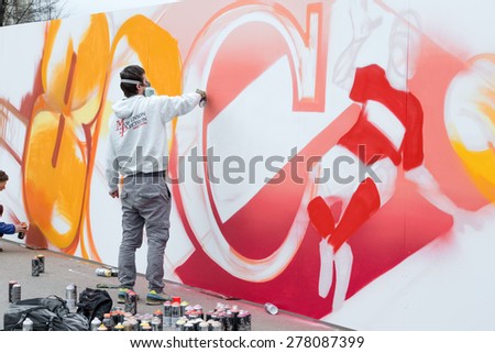 RUSSIA, MOSCOW - APRIL 18: Unidentified graffiti artist works on his creation for the celebration on the 80th anniversary of the Spartak sports society in Luzhniki, Moscow, Russia, 2015