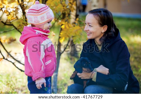 A family portrait of a single mom, her daughter and  dog set in a beautiful autumn forest