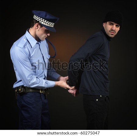 Police officer arretign a thief. Dark background. Square format