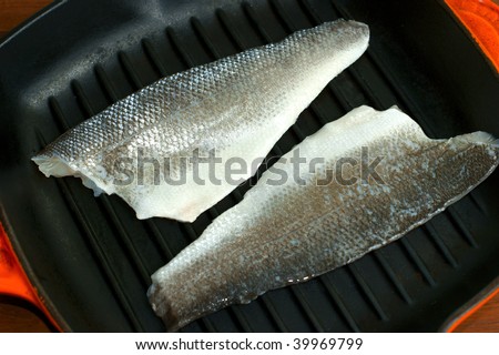 Uncooked Seabass in a griddle pan