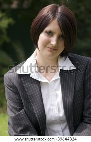 Portrait of a beautiful young professional woman with a black pinstripe suit.