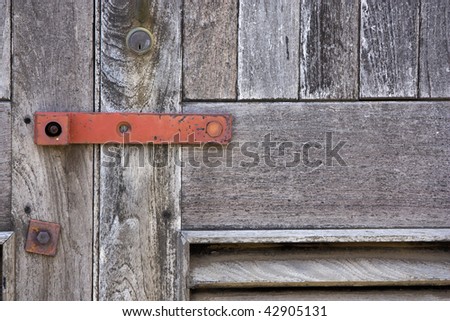 Close up of a sealed and locked up wooden door.