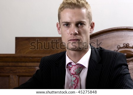 Portrait of a young business man with a black pinstripe suit.