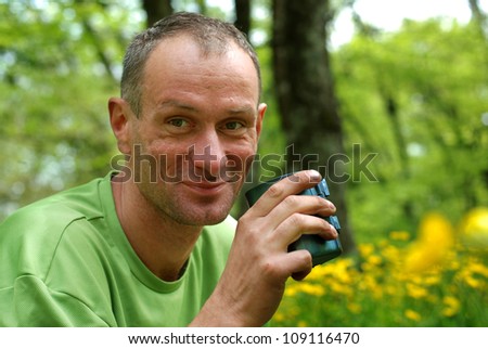 Spring  Crimea hiking. Smiling man with a mug of tea