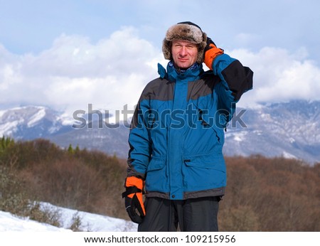 Cold winter in the Crimean mountains. Hiker in  russian hat