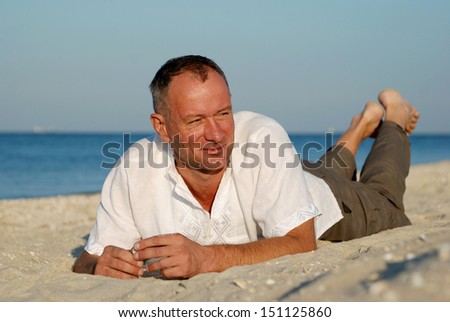 Early morning on the Azov Sea. Man resting on the beach