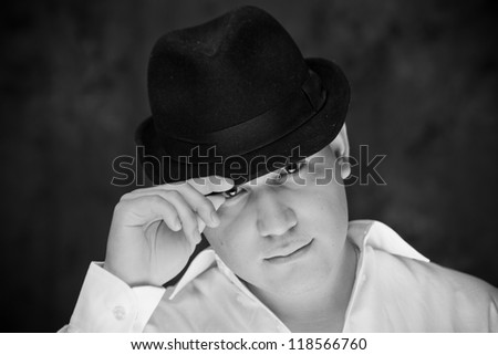 Man in a fedora hat looking at you