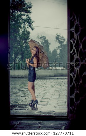 Woman with umbrella in the rain vintage look