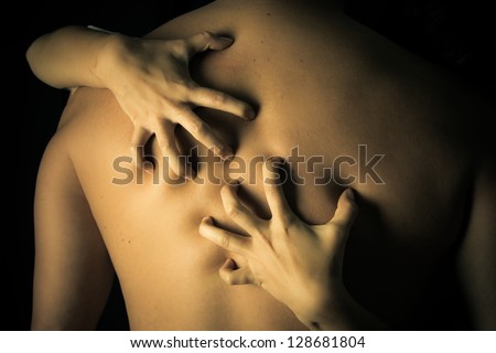 Back of a Man  with a woman\'s hands scratching his back