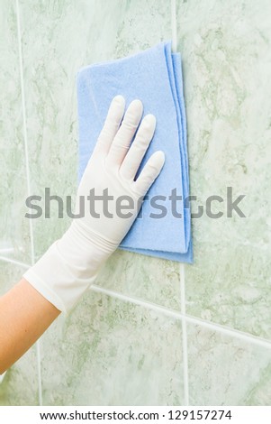 Female household, tile cleaning with rag and gloves