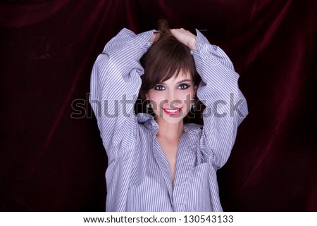 Beautiful Young Woman with hands on face and wearing a mans shirt.  Great detail in mouth and eyes.