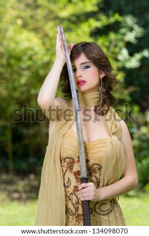 Beautiful female fighter with a sword in her hands.