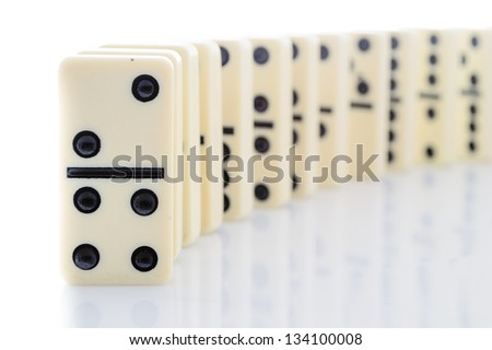 Domino effect - row of white dominoes isolated on white background