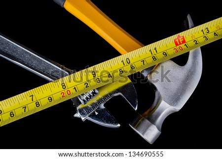 set of tools and instruments on wood background, hammer, tape measure, wrench