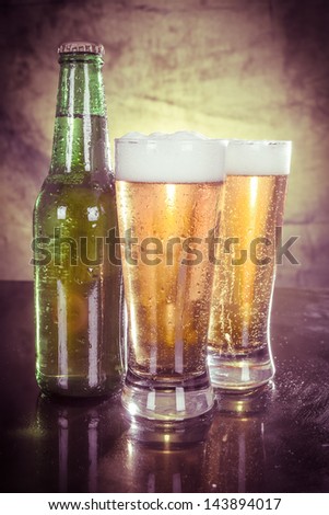 Glasses of beer with green bottle color processed