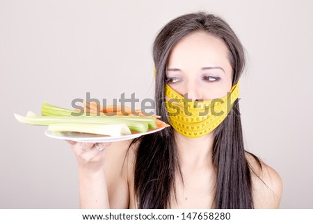 A woman has a tape around her mouth.