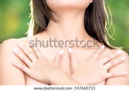 close up, topless woman body covering her breast with hand, cancer awareness