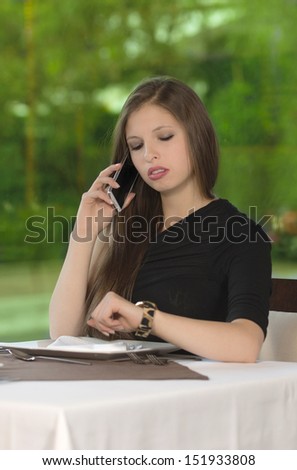 Hungry woman is waiting in a restaurant